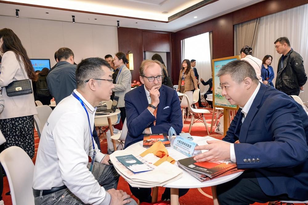 Three business delegates in discussion at a round table