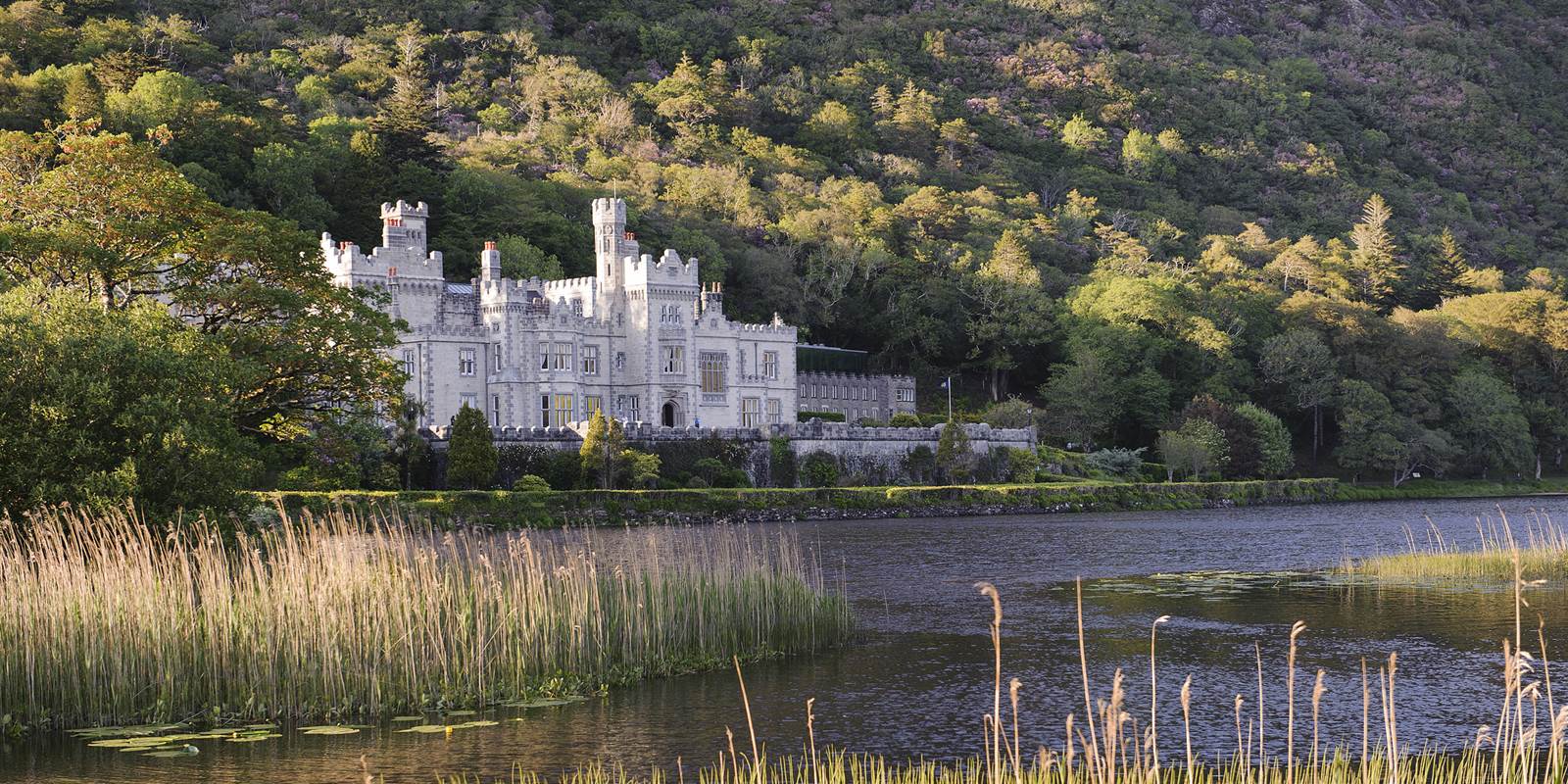 Kylemore Abbey across a lily-covered lake in Connemara
