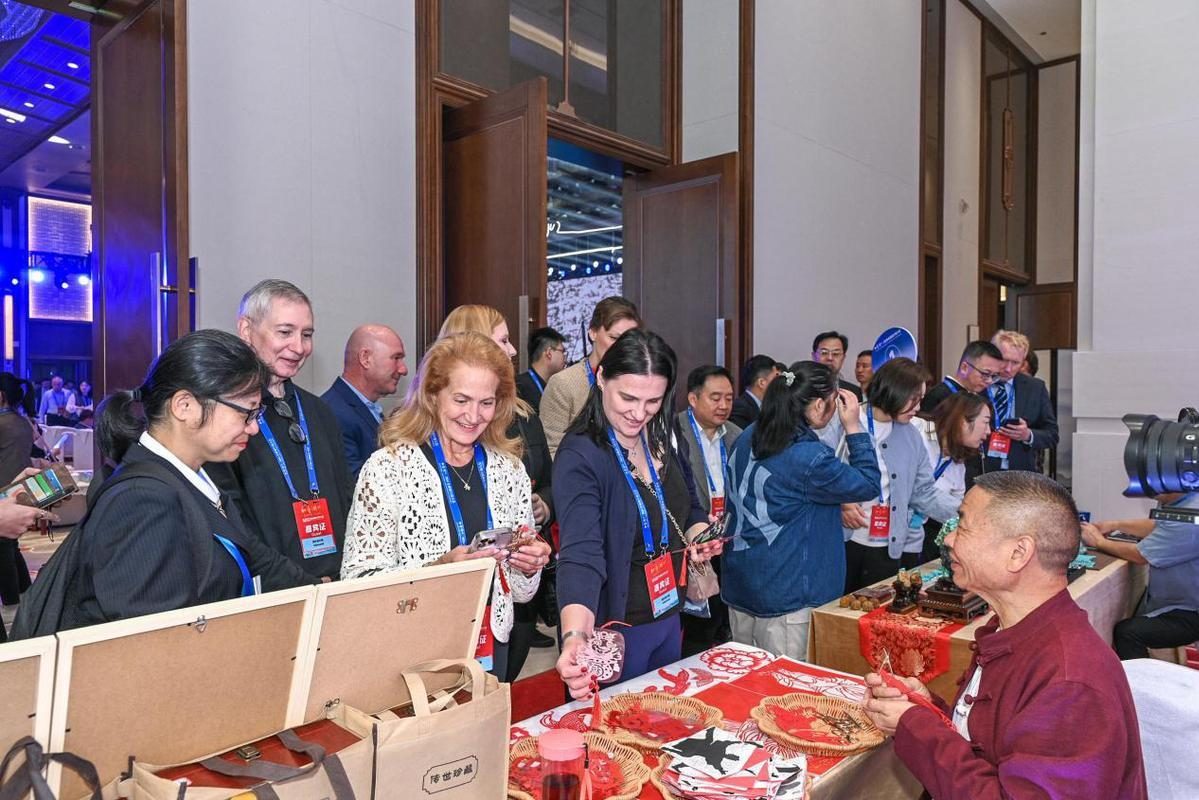 Trade delegates exchanging gifts and promotional items at an exhibition stand